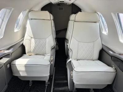 Luxury Cessna Citation interior featuring custom cabinetry and reconfigured seating